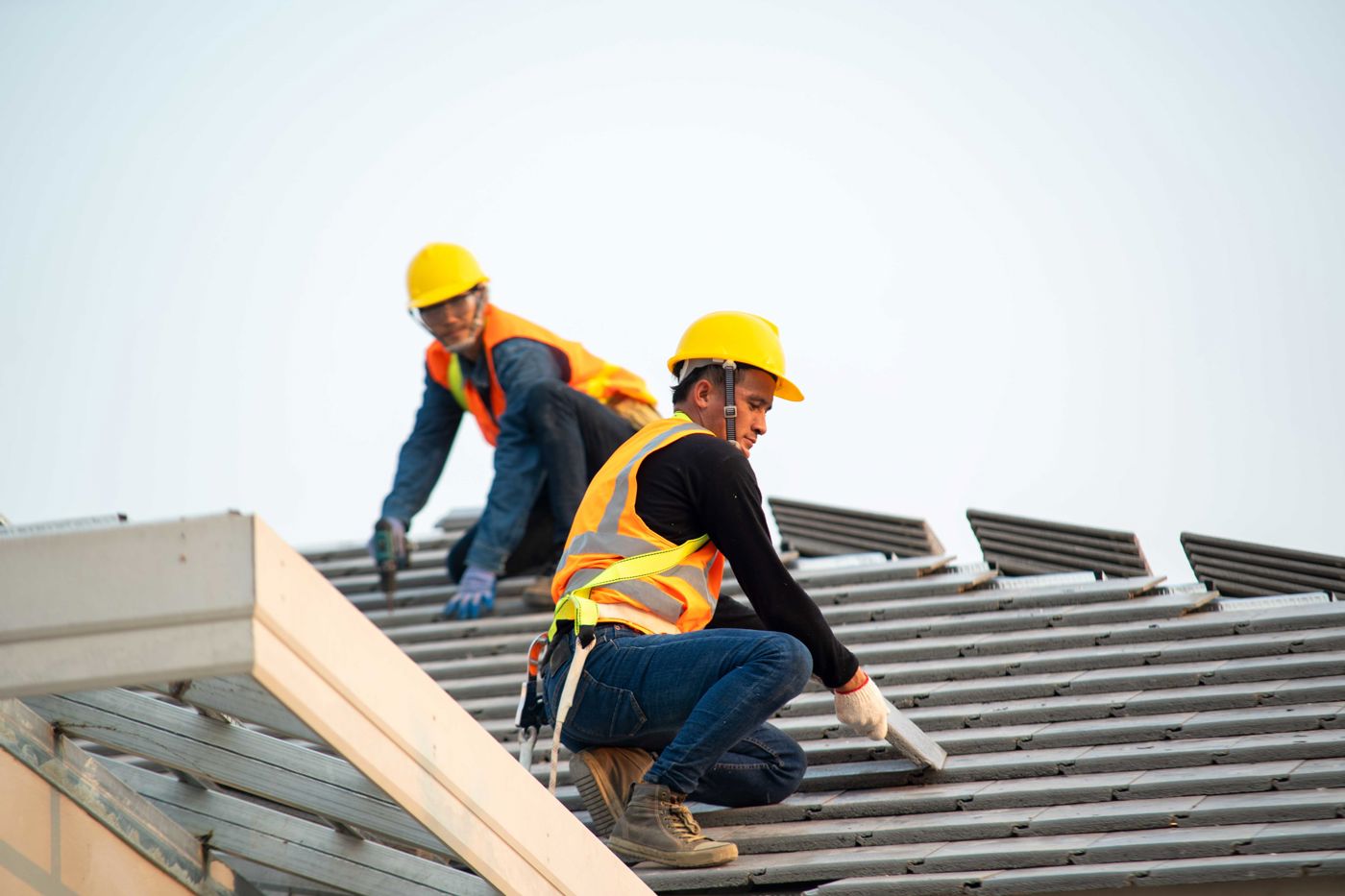 24-7 roofers fitting new tiles on a pitched roof